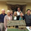 Hatfields & McCoys with community members around McCoy Cabin model