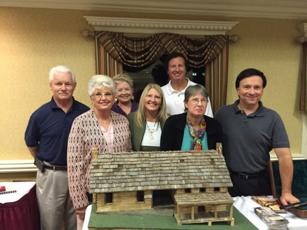 Hatfields & McCoys with community members around McCoy Cabin model